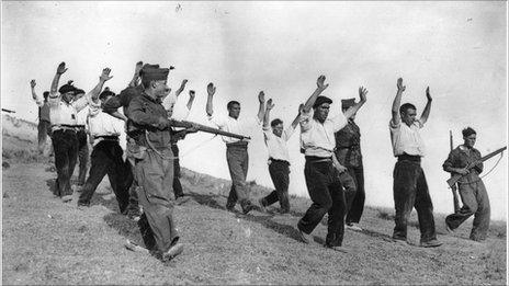 Soldiers of Gen Franco's Nationalists escort captured Republican troops in the Spanish Civil War
