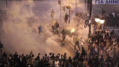 Demonstrators run away from tear gas during a demonstration in Athens on 28 June 2011