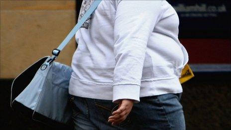 An overweight person walks through Glasgow City centre