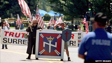 Members of the white supremacist group Aryan Nations march under the surveillance of police in Coeur d'Alene, Idaho