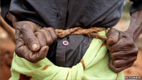 A woman binds her stomach to stave off hunger