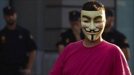 A demonstrator wearing an "Anonymous" group mask attends an assembly against the "Euro Pact" and the handling of the economic crisis near Madrid"s Parliament