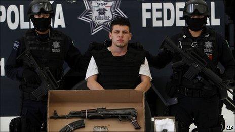Nery Salgado Harrison is escorted by police during his presentation to the media in Mexico City, Monday 1 August 2011