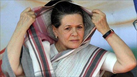 In this photograph taken on October 18, 2010, India"s Congress Party President Sonia Gandhi covers her head as she addresses supporters at an election meeting in Kishanganj ahead of elections in the eastern state of Bihar.