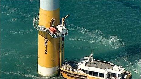 A workboat is transferring staff to a turbine