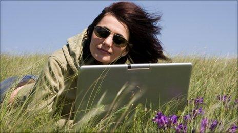 Woman with laptop in open air