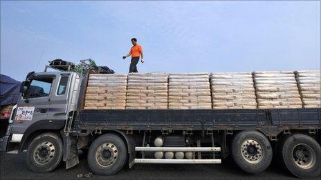 A South Korean driver checks a load of North Korea-bound flour on his truck on 26 July 2011