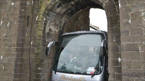 Coach driving through Conwy town wall archway