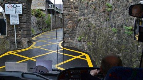 Coach approaching Conwy town wall archway