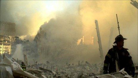 A firefighter walks through dust and debris on September 11, 2001