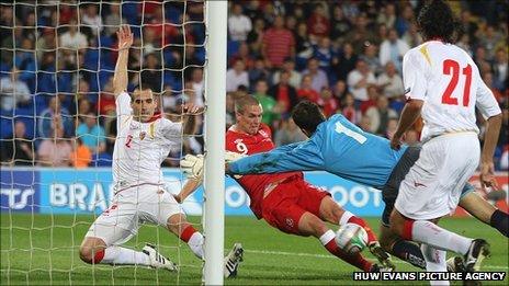 Wales striker Steve Morison slides in to score his first international goal