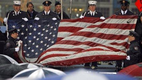 The World Trade Center flag is folded during a memorial service in New York for the victims of the attacks.