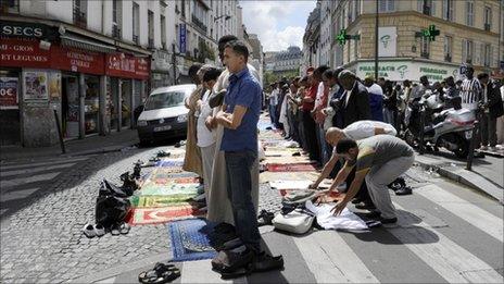 Muslims pray in a Paris street, 5 August 2011