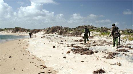 Kenyan police patrol a beach near the Kiwayu resort