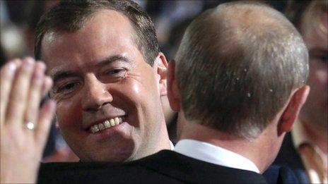 Dimitry Medvedev looks over the shoulder of Vladimir Putin at the United Russia party congress in Moscow, 24 September