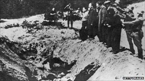 1941. Nazi commanders line up Jews to shoot them and push them into the Babi Yar ravine.