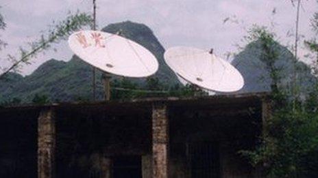 Satellite dishes on a building in China (file)