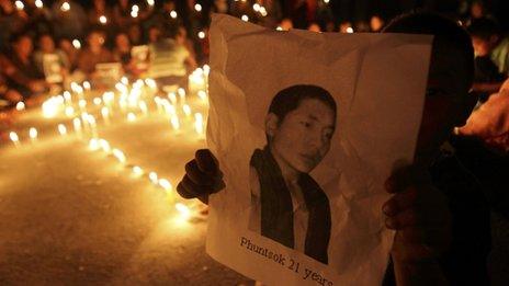 A Tibetan child holds a portrait of Tibetan monk Phuntsog who killed himself through self-immolation, during a memorial at the Tibetan Refugee Centre in Lalitpur, Nepal on 11 October 2011
