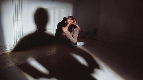 Man sitting in person's shadow