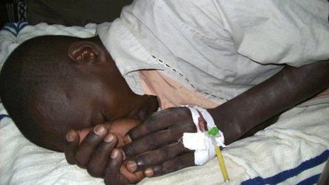An injured man lies in a hospital bed after an attack in Garissa, 24 November 2011.