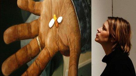 A lady views Damien Hirst's oil on canvas painting 'HIV AIDS, Drugs Combination'