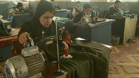 Women working with men in a textile factory near Kabul