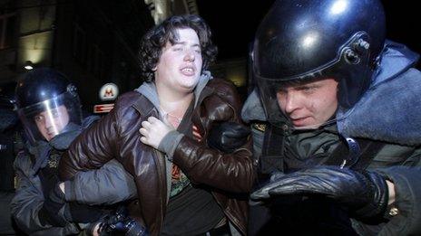 Moscow riot police detain a protester, 6 December