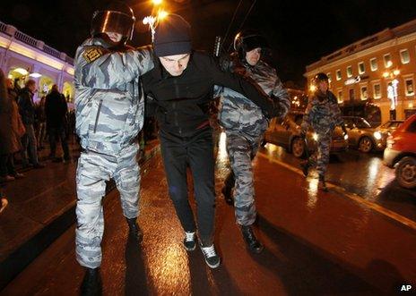Russian police detain a protester in St Petersburg, 6 December