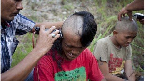 Police shave the hair of detained Indonesian punks at a police school in Aceh Besar in Aceh province