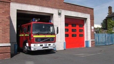 A fire engine leaving a fire station