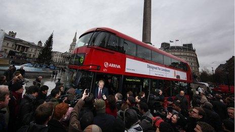 London Mayor Boris Johnson talks to reporters from a new prototype red double decker bus in Trafalgar Square