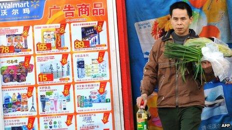 A Chinese shopper leaves a Walmart store in Beijing
