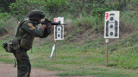 A member of the Colombian police's special ops team trains on a shooting range