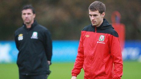 Former Wales coach Gary Speed (background) and captain Aaron Ramsey