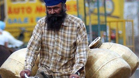 File photo of an Indian milk man returning home after his morning round in Amritsar (27 May 2008)