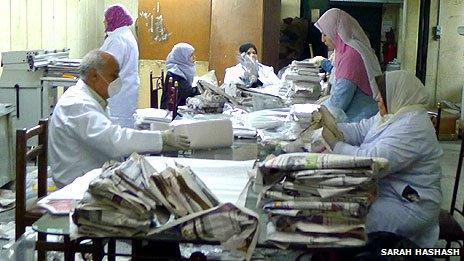 Book restorers work at tables