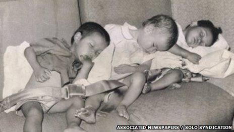 Lê Thanh (L) asleep on the plane with other orphans as they are airlifted out of Vietnam