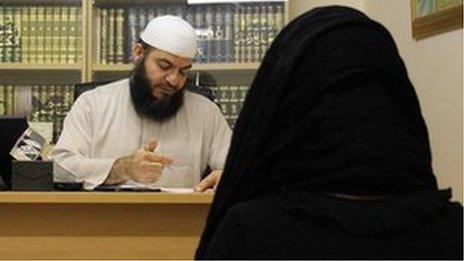Sheikh Haitham Al-Haddad with a woman client at the Islamic Sharia Council