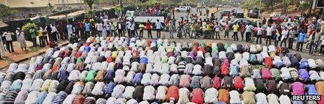 Muslims pray while Christians form a protective human chain around them during a protest against the elimination of a popular fuel subsidy that has doubled the price of petrol in Nigeria's capital Abuja, January 10, 2012.