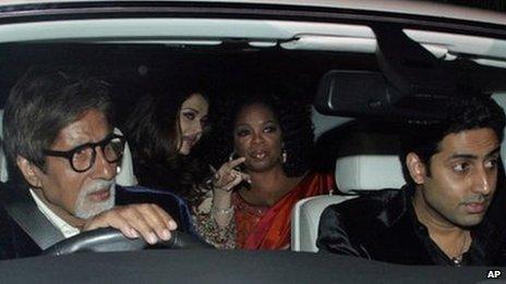 Indian actor Amitabh Bachchan drives with son Abhishek and daughter-in-law Aishwarya Rai (centre) in a car with Oprah Winfrey in Mumbai on 16 Jan 2012