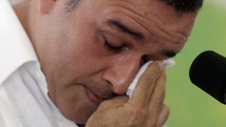 President Mauricio Funes wipes a tear while apologizing for the massacre of El Mozote on 16 January 2012