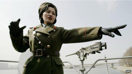 A North Korean guide shows tourists around the USS Pueblo