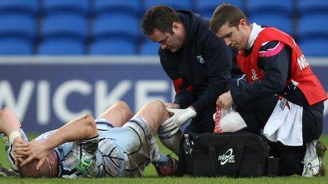 Gethin Jenkins receives treatment to a knee injury during the Heineken Cup win over Racing Metro