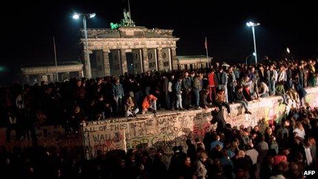 East Berliners climbing onto the Berlin wall in 1989