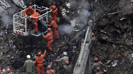 Rescuers remove the body of a victim from the rubble of a collapsed building in Rio de Janeiro