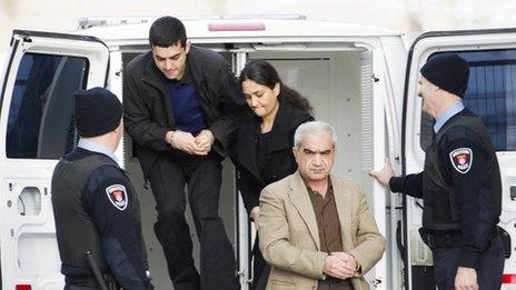 Mohammad Shafia, front, Tooba Yahya, centre, and their son Hamed Shafia arriving at court in Kingston, Ontario (28 January)