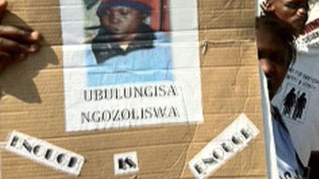 People hold up a poster of Zoliswa Nkonyana at a court hearing in September 2011 Copyright: Malungelo Booi/EWN