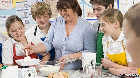 Teacher showing children how to cook