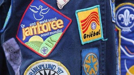 Shirt badges are displayed by a boy scout