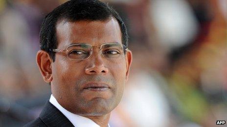 In this photograph taken on December 27, 2011, Maldivian President Mohamed Nasheed looks on while attending a military parade in the central Sri Lankan town of Diyatalawa